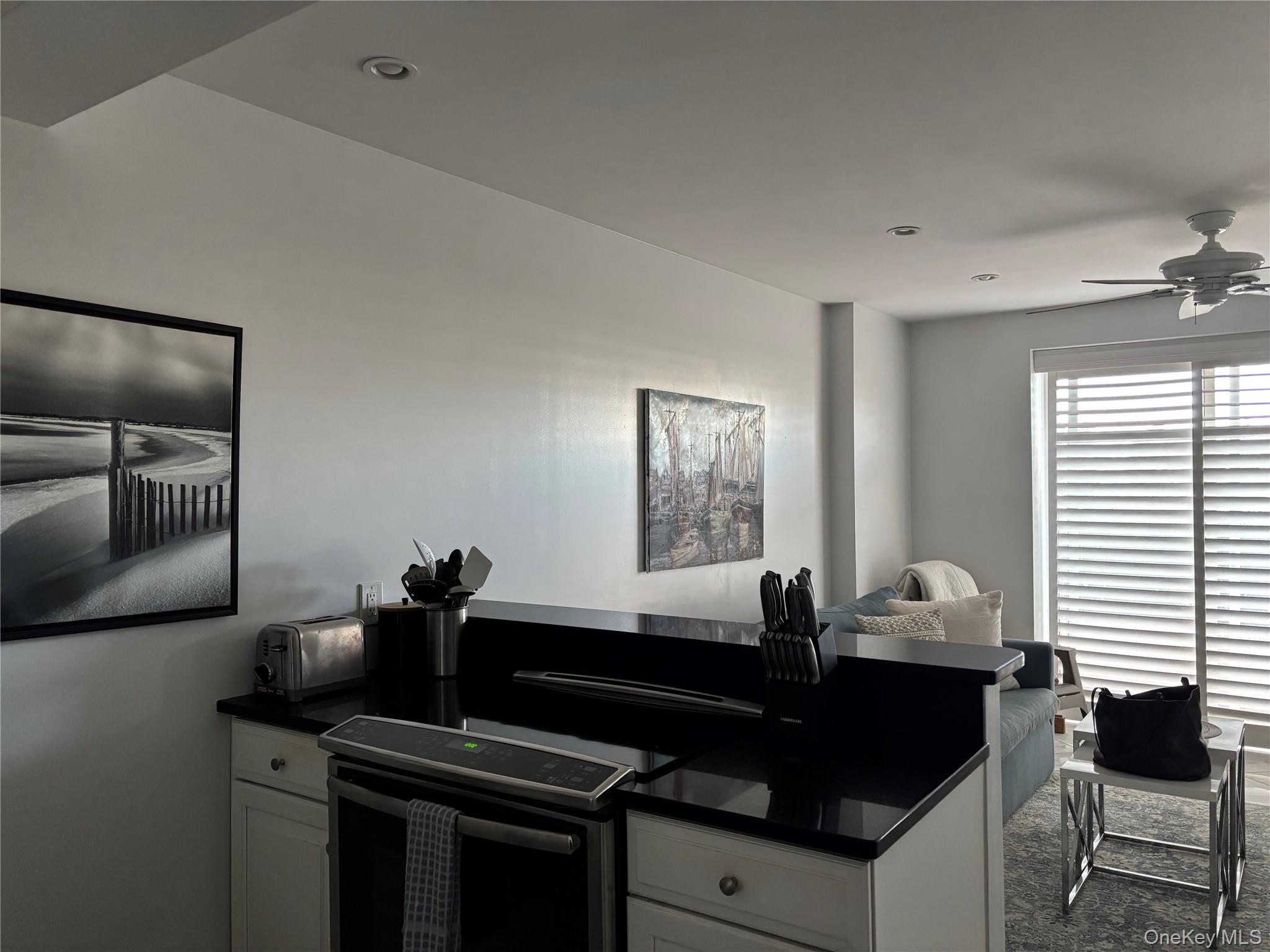 2 Richmond Road, Unit 1K Lido Beach, NY 11561 - Photo 7 of 18 a kitchen with granite countertop a sink and cabinets