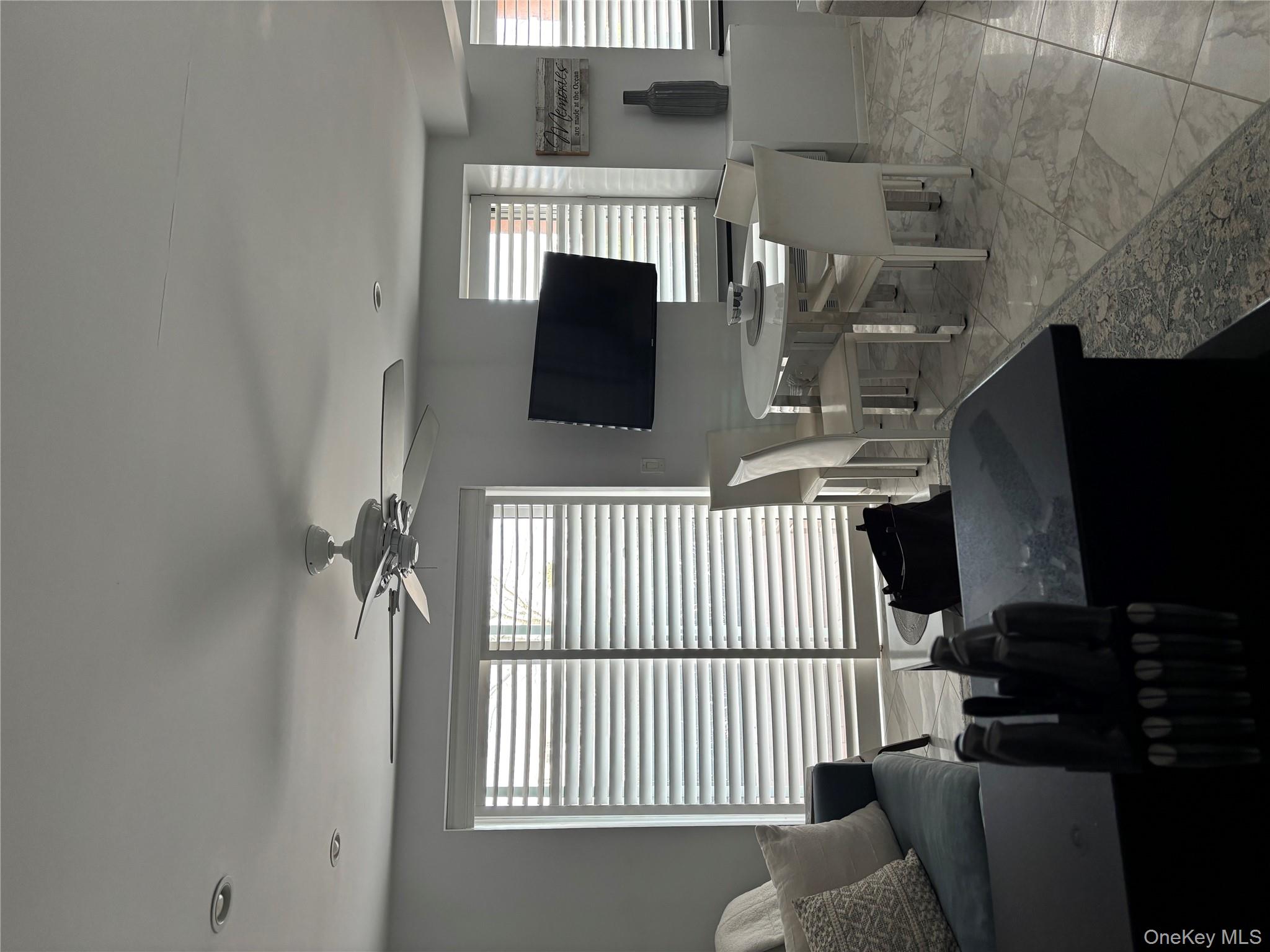 2 Richmond Road, Unit 1K Lido Beach, NY 11561 - Photo 9 of 18 a living room with furniture and a flat screen tv