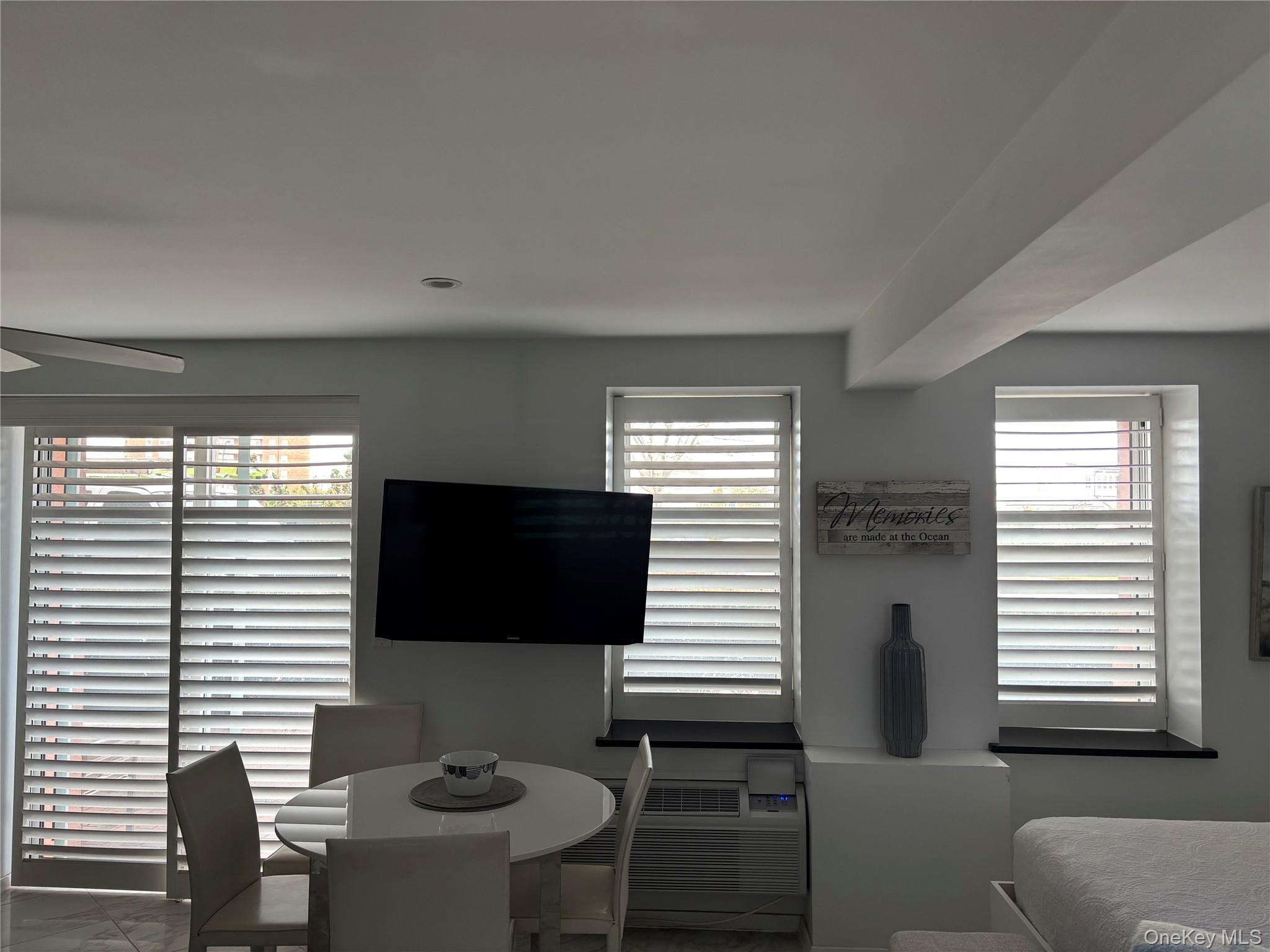 2 Richmond Road, Unit 1K Lido Beach, NY 11561 - Photo 10 of 18 a living room with furniture and a flat screen tv