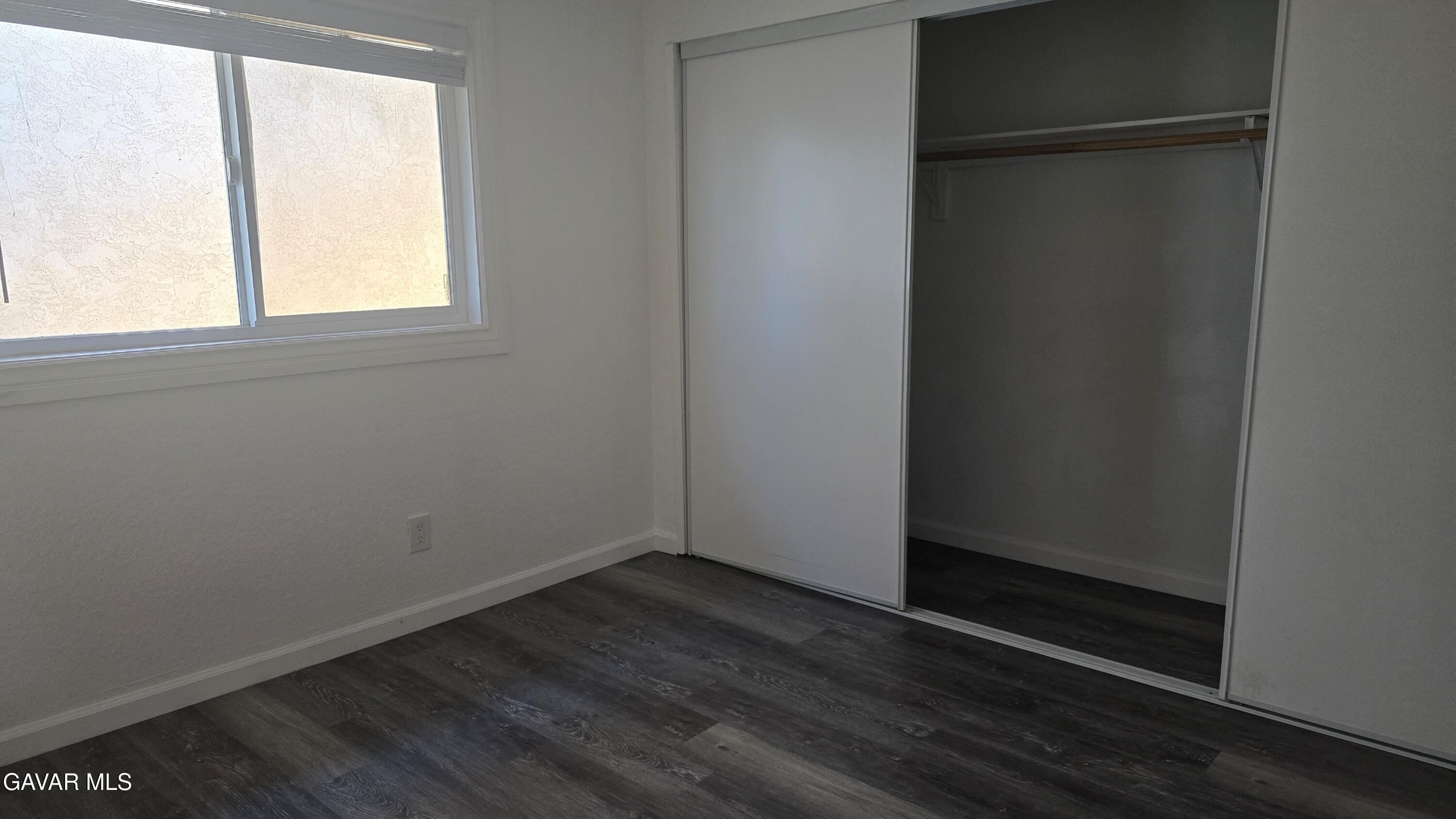 38551 10th Place East, Unit A Palmdale, CA 93550 - Photo 12 of 18 an empty room with wooden floor and windows