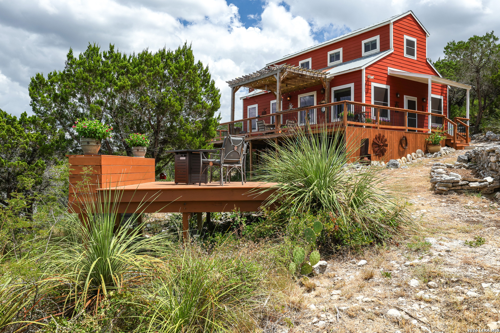 776 County Road 270 Mico, TX 78056 - Photo 2 of 59 a front view of a house with a yard and potted plants