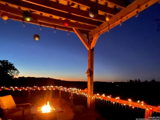 a view of a yard with wooden fence