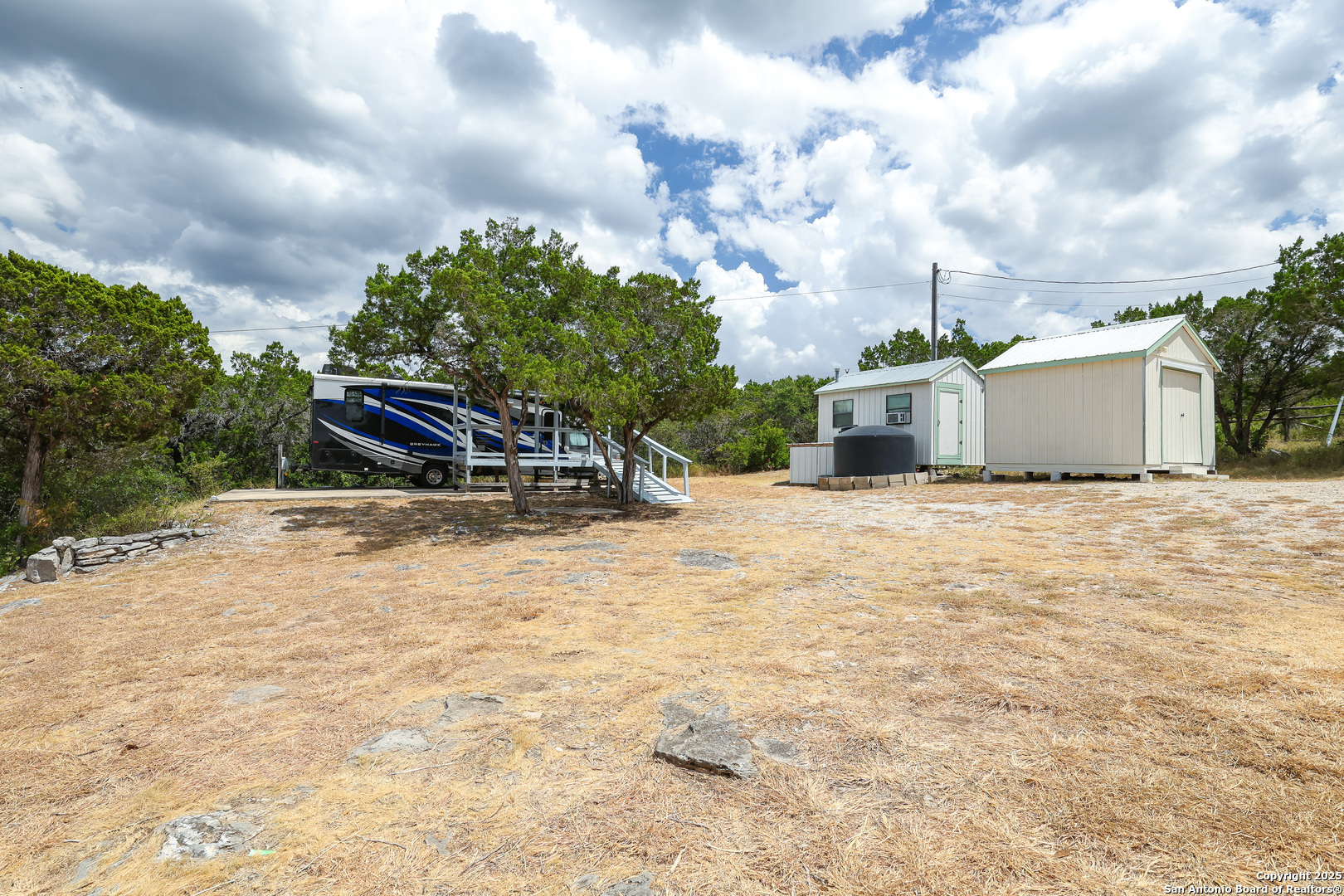 776 County Road 270 Mico, TX 78056 - Photo 42 of 59 a view of a white house with a yard and sitting area