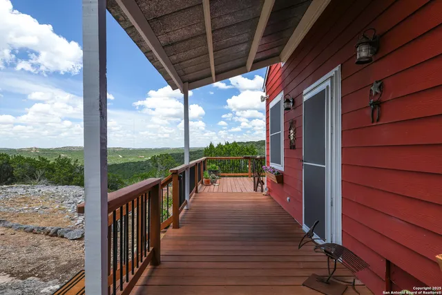 a view of a chairs and table in the balcony