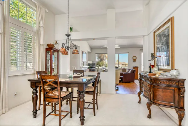 a view of a a dining room with furniture window and outside view