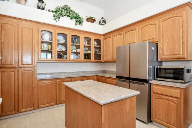 a kitchen with stainless steel appliances a stove microwave and refrigerator