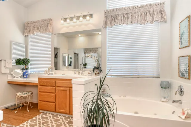 a bathroom with a bathtub sink and mirror