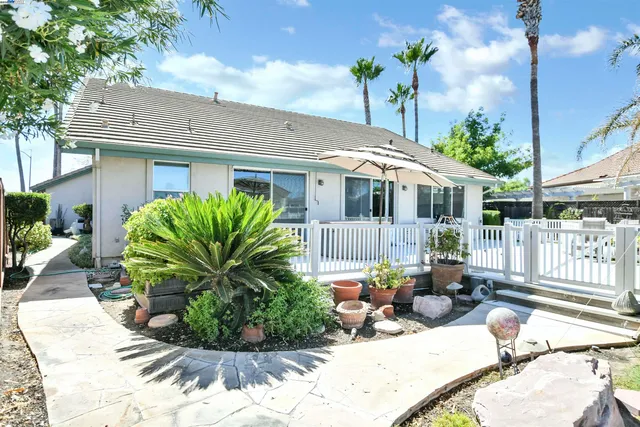 a view of a house with backyard sitting area and porch