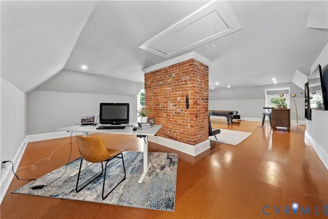 an aerial view of residential houses with outdoor space and trees