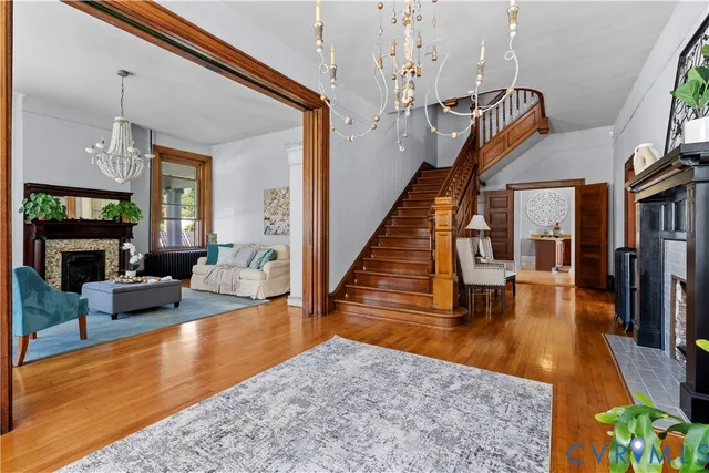 a dining room with furniture a fireplace and large windows