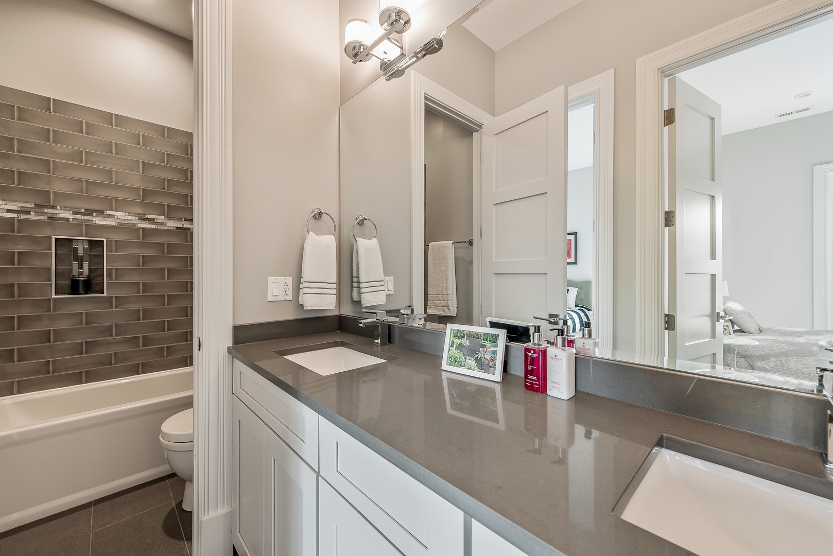 290 Thackeray Lane Northfield, IL 60093 - Photo 20 of 30 a bathroom with a granite countertop sink and a mirror