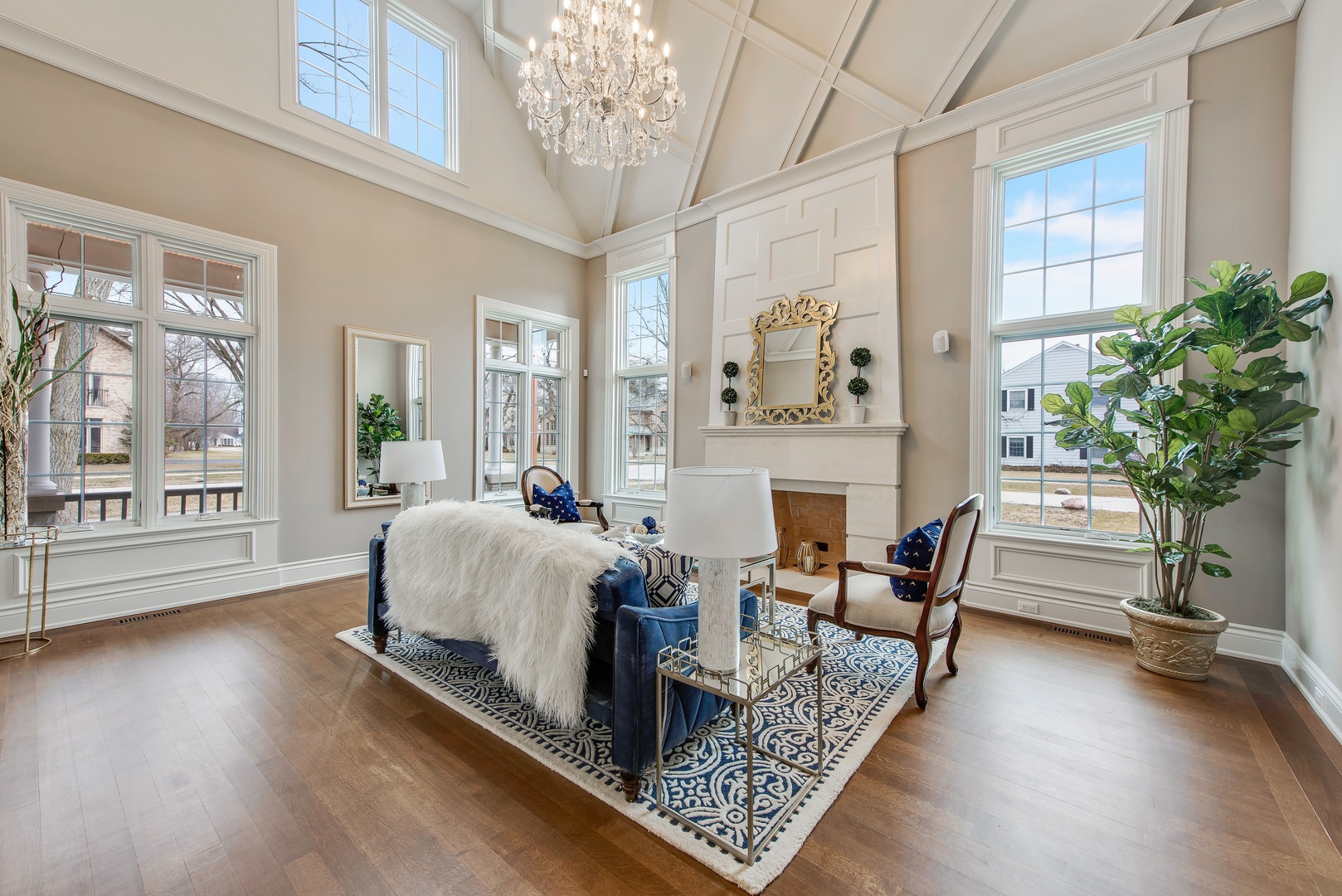 290 Thackeray Lane Northfield, IL 60093 - Photo 3 of 30 a living room with furniture a chandelier and a fireplace