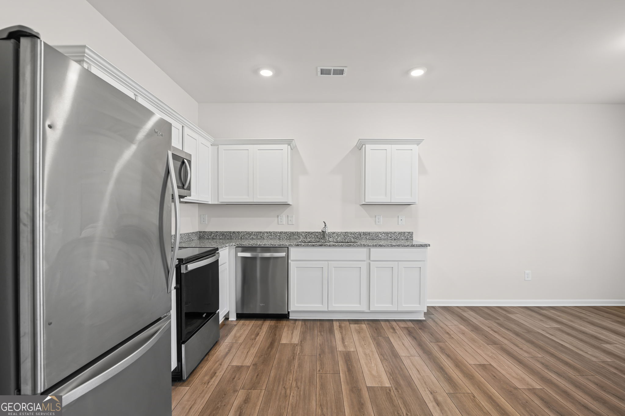 1002 Depot Street Cartersville, GA 30120 - Photo 12 of 29 a kitchen with granite countertop a refrigerator stove and sink