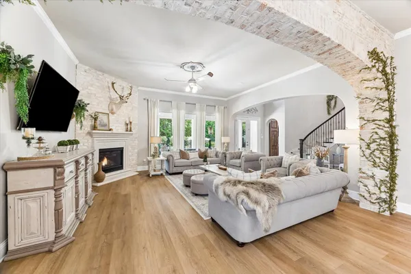 a living room with furniture a fireplace and a flat screen tv
