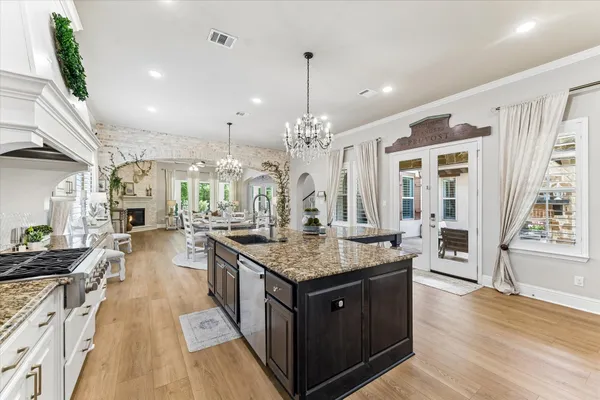 a large kitchen with kitchen island a sink a stove and a center island