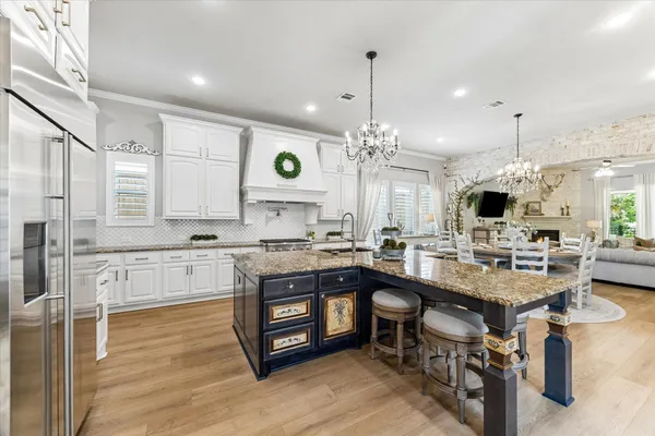 a kitchen with a stove and a wooden floor