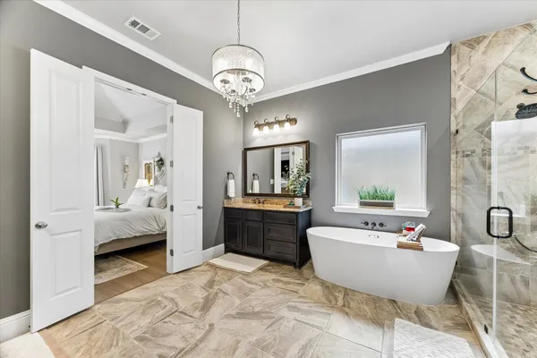 a spacious bathroom with a tub sink and mirror