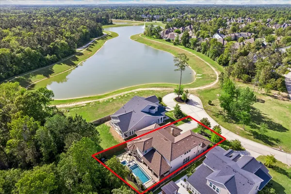 an aerial view of a house with a lake view