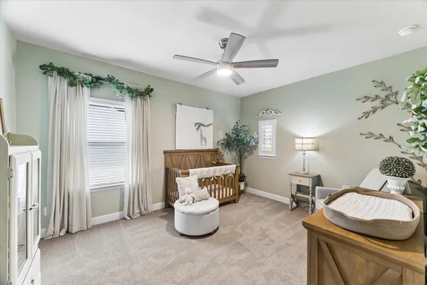 a bedroom with furniture and a chair