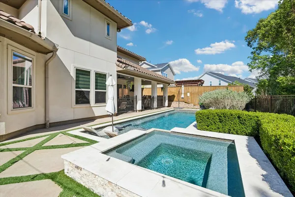 a view of a backyard with swimming pool