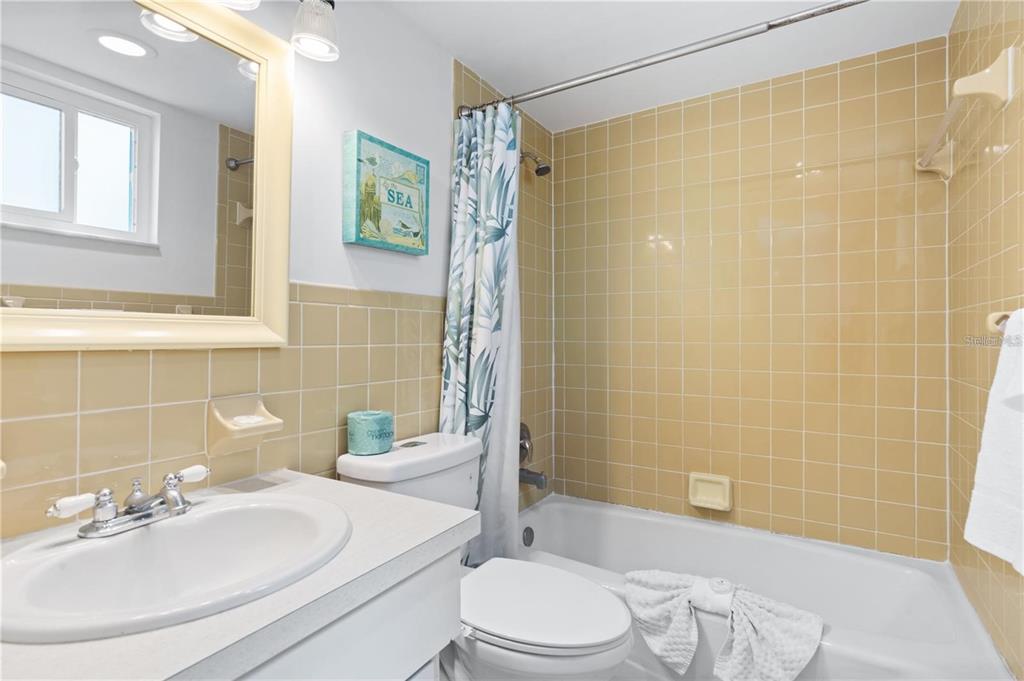 17300 Gulf Boulevard, Unit 9 North Redington Beach, FL 33708 - Photo 11 of 15 a bathroom with a sink a toilet and shower