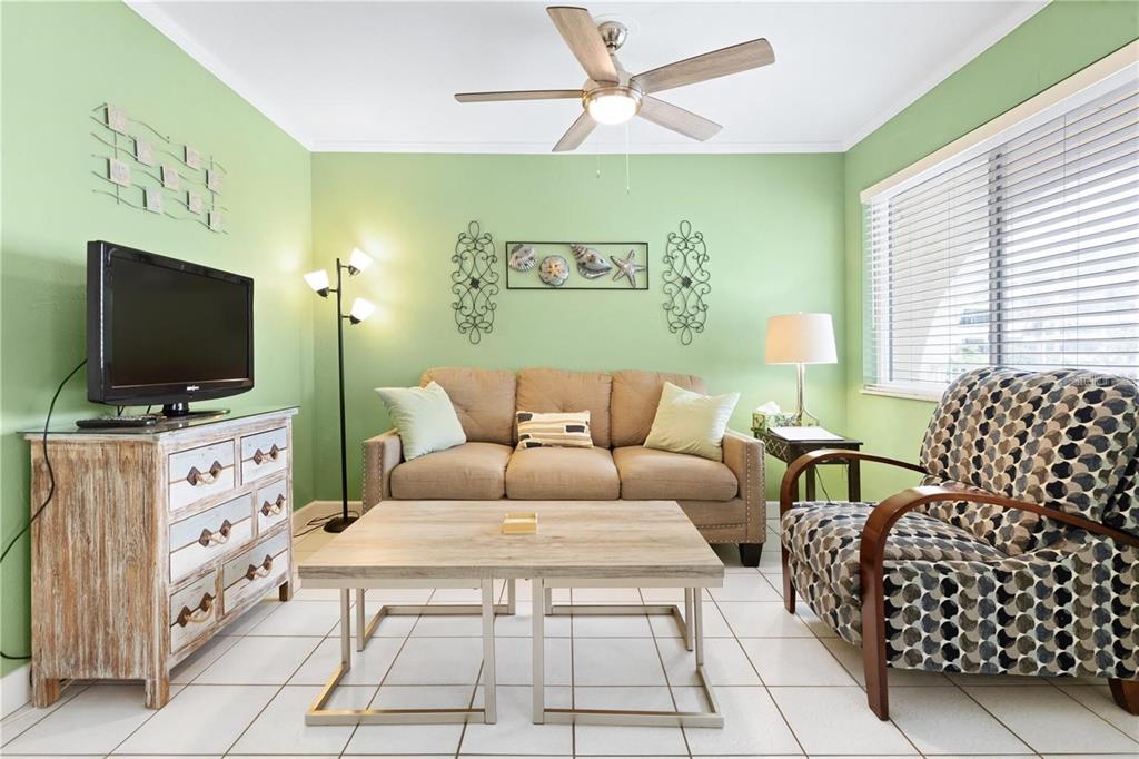 17300 Gulf Boulevard, Unit 9 North Redington Beach, FL 33708 - Photo 4 of 15 a living room with furniture and a flat screen tv