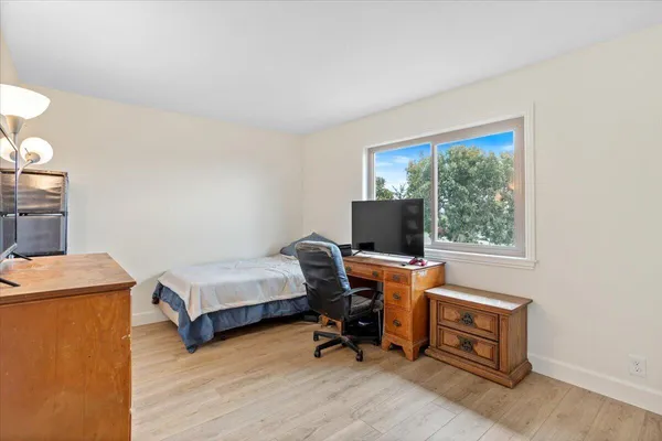 a view of a workspace with furniture and a window