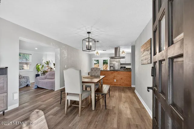a kitchen with kitchen island a counter top space a sink stainless steel appliances and cabinets