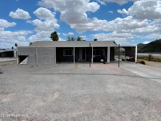 a view of a house with a backyard and sitting area