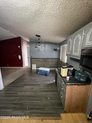 a kitchen with granite countertop a stove and cabinets