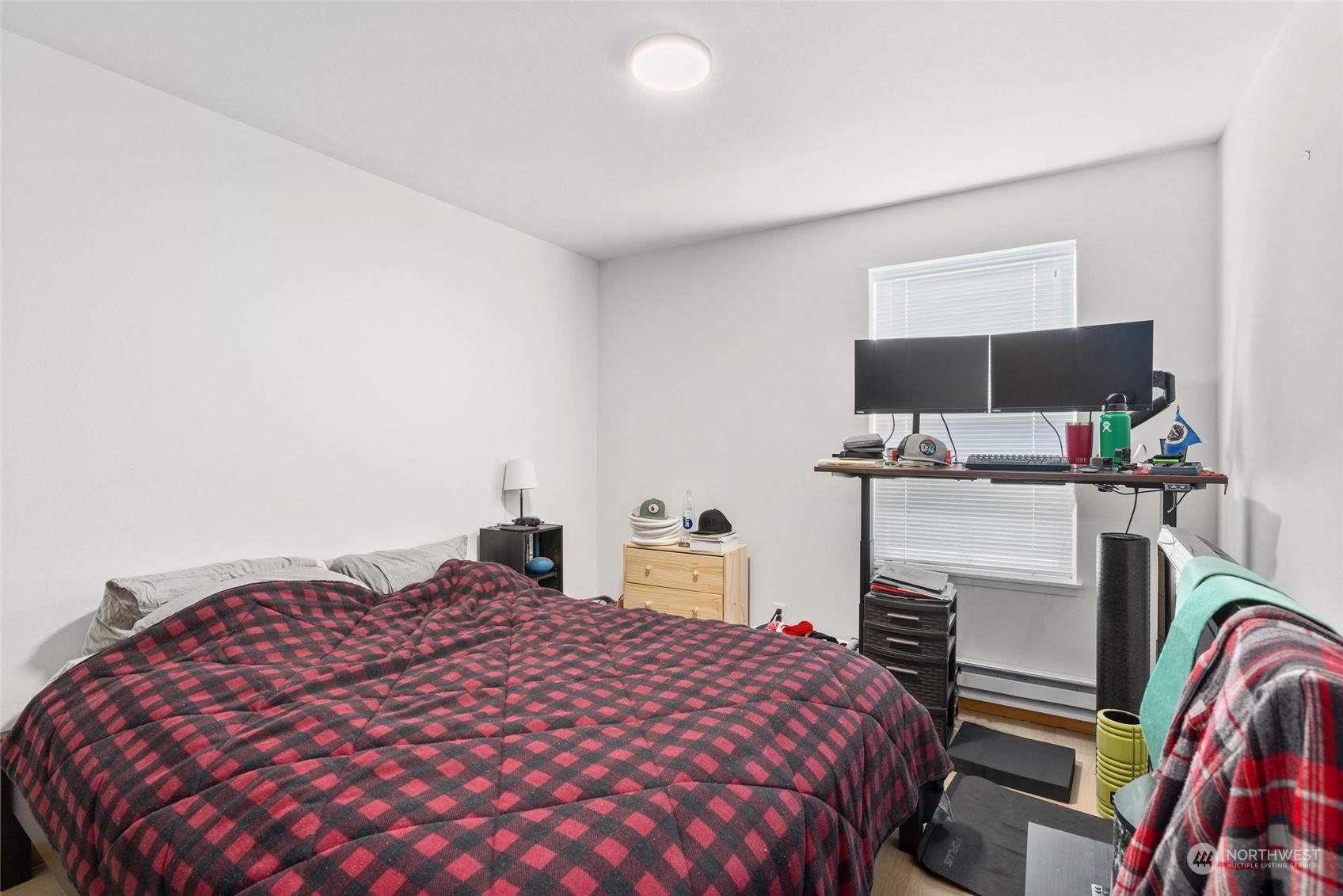 3435 Burke Avenue North Seattle, WA 98103 - Photo 12 of 21 a bedroom with a bed and a flat screen tv
