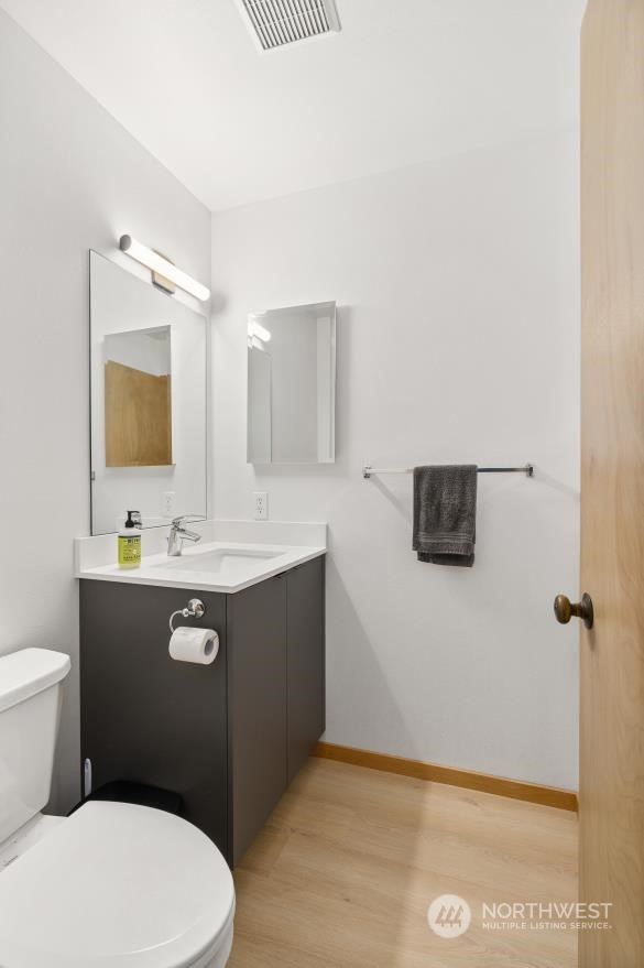 3435 Burke Avenue North Seattle, WA 98103 - Photo 15 of 21 a bathroom with a sink mirror vanity and toilet