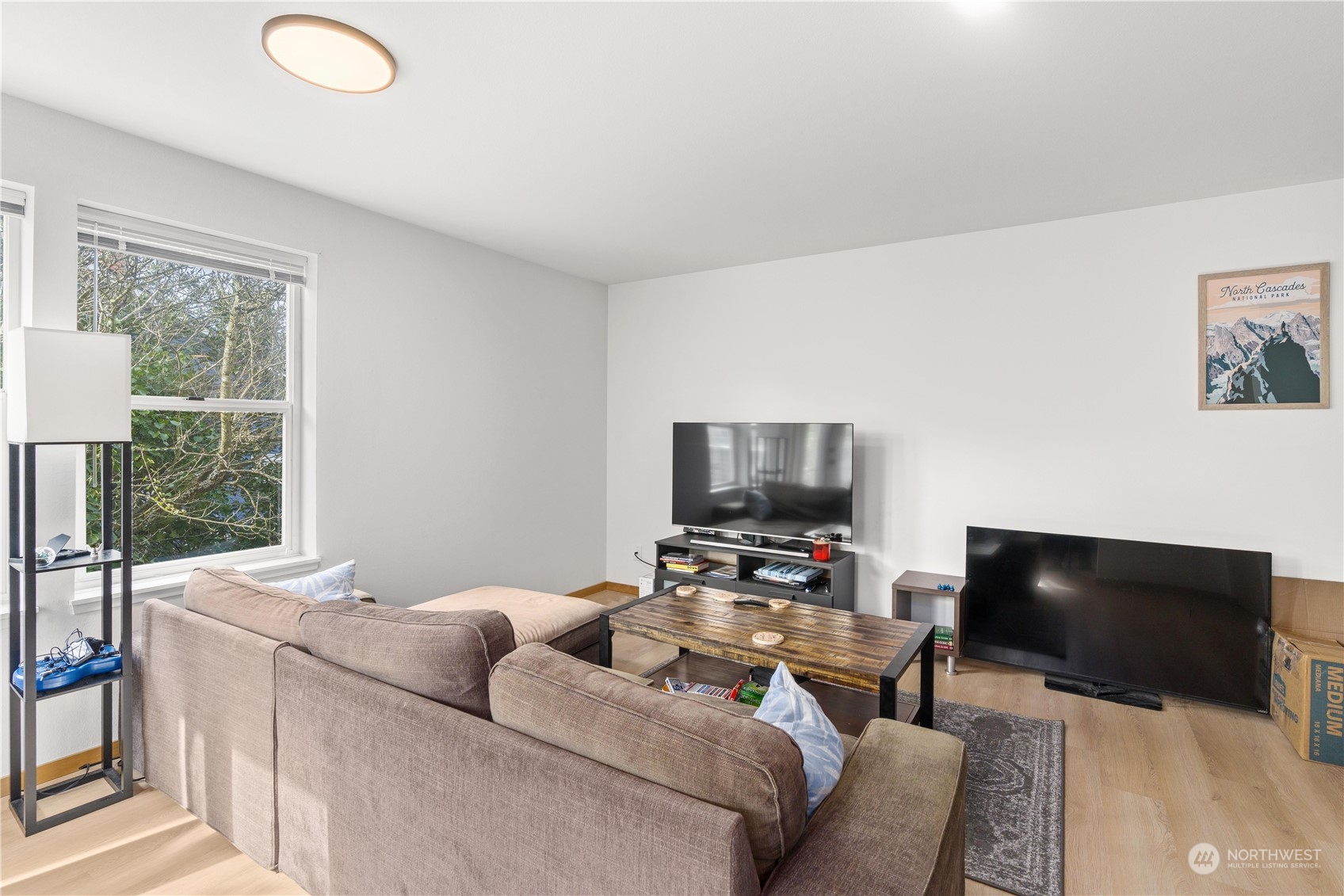 3435 Burke Avenue North Seattle, WA 98103 - Photo 7 of 21 a living room with furniture and a flat screen tv
