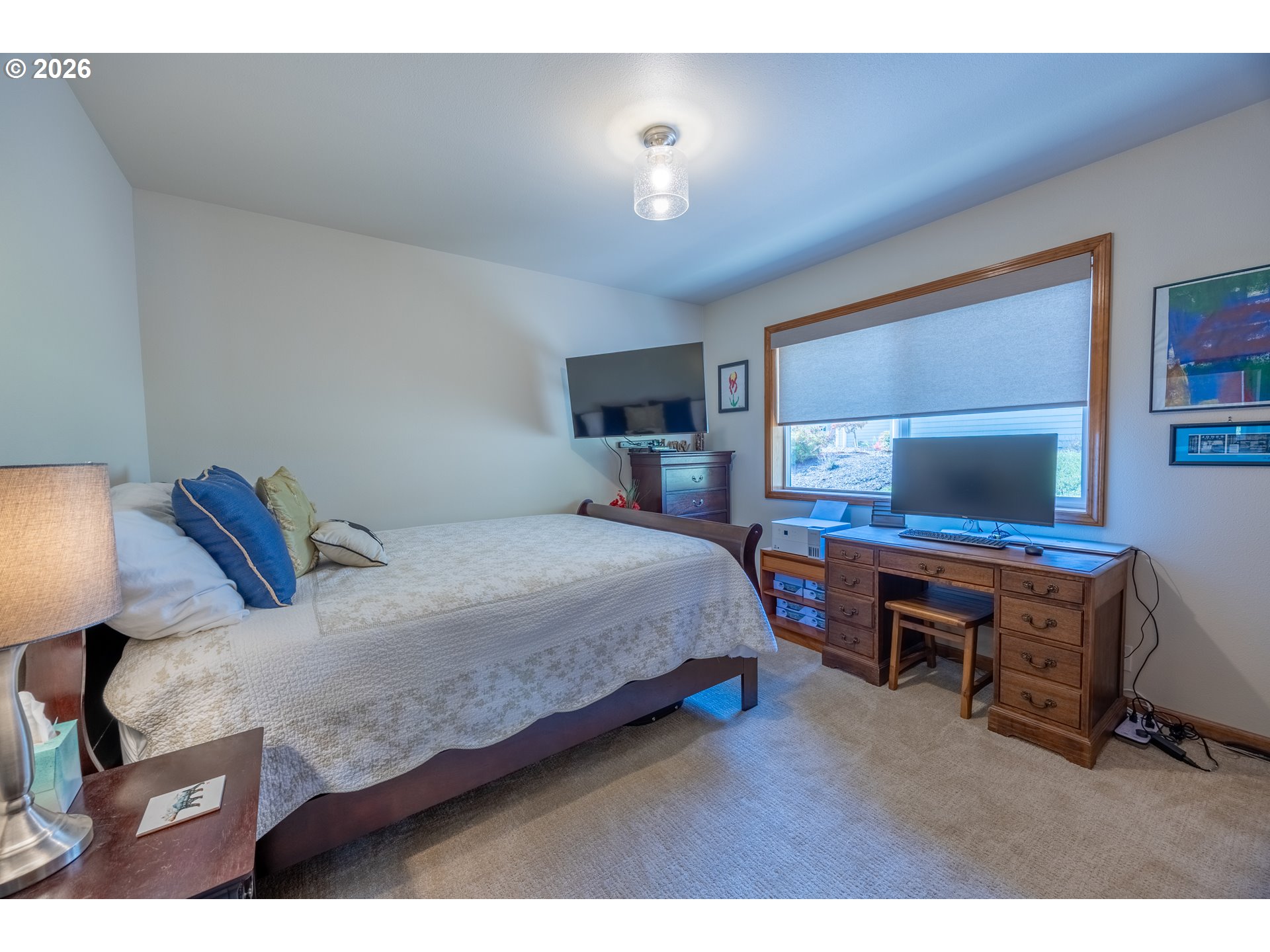 2193 13th Street Florence, OR 97439 - Photo 39 of 48 a bedroom with a bed and a table in it