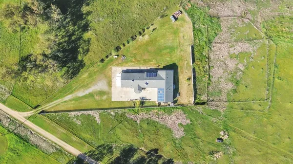 a large white kitchen with stainless steel appliances granite countertop a refrigerator a oven and a sink