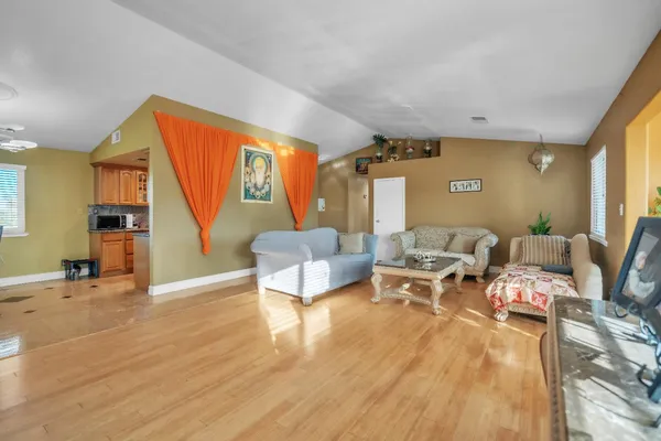 a bedroom with a bed dresser and a chandelier