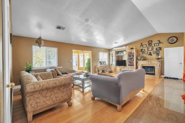 a living room with furniture and a chandelier