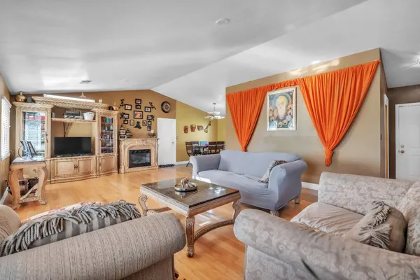 a spacious bedroom with a bed and a chandelier