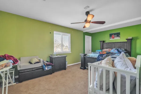 a bedroom with a bed and a chandelier