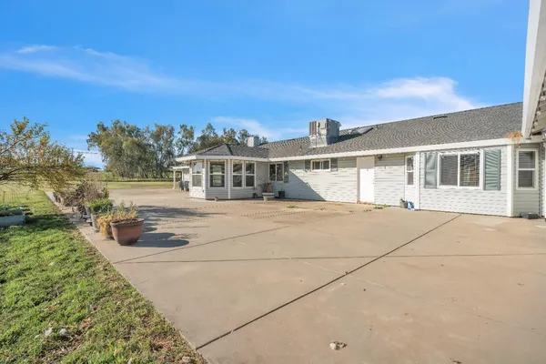 a view of a house with a yard and ocean view