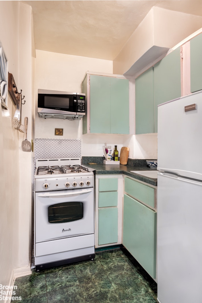 225 East 36th Street, Unit 5C Manhattan, NY 10016 - Photo 4 of 7 a kitchen with a stove and a refrigerator