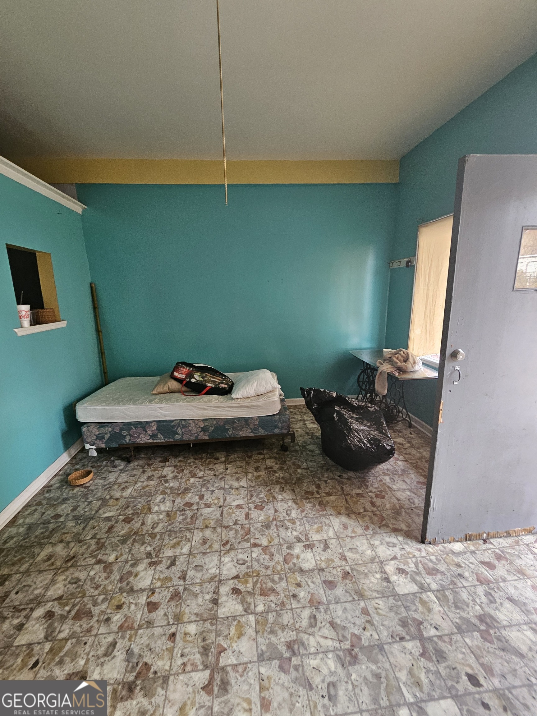 109 F Avenue Thomaston, GA 30286 - Photo 21 of 25 a bedroom with a bed and a mirror