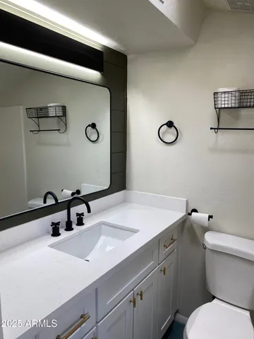 a white toilet sitting next to a bathroom sink