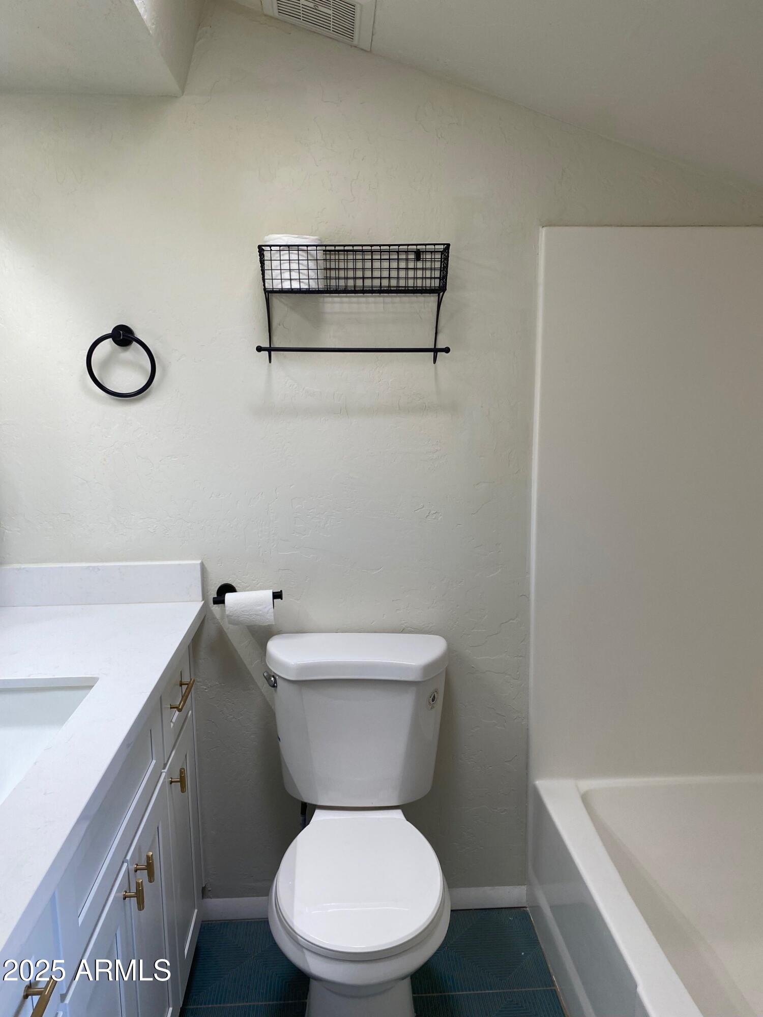 1821 West Libby Street Phoenix, AZ 85023 - Photo 14 of 26 a white toilet sitting next to a bathroom sink