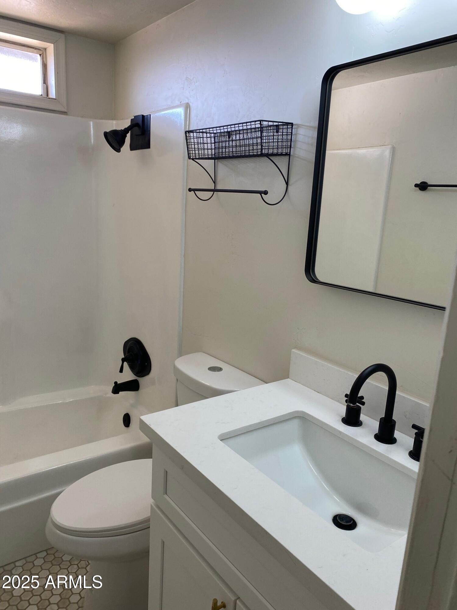 1821 West Libby Street Phoenix, AZ 85023 - Photo 16 of 26 a bathroom with a sink a toilet and shower