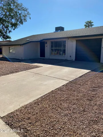an empty room with a cabinet and mirrors