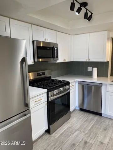 a stove top oven sitting inside of a kitchen