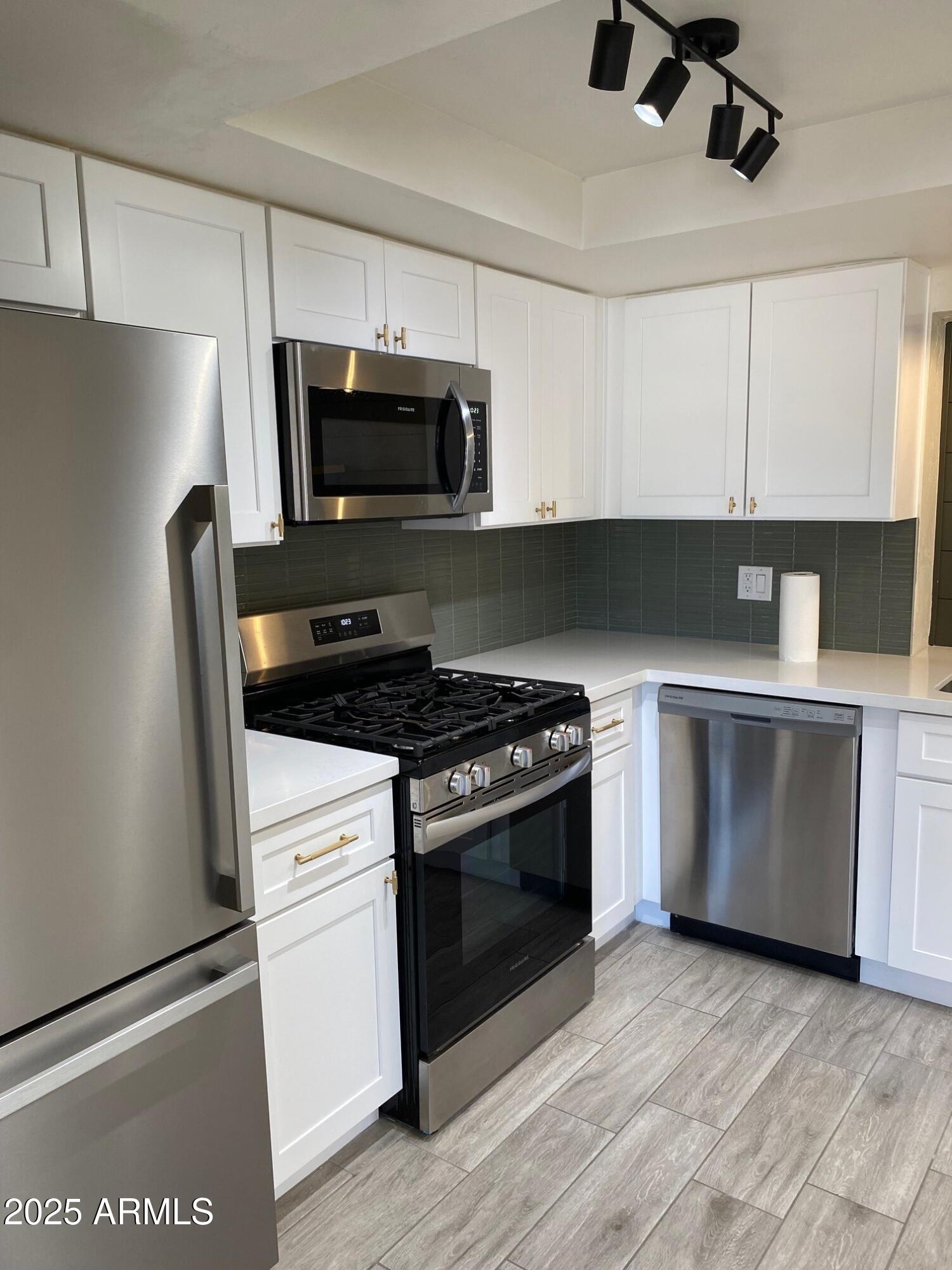 1821 West Libby Street Phoenix, AZ 85023 - Photo 6 of 26 a kitchen with a stove and a microwave