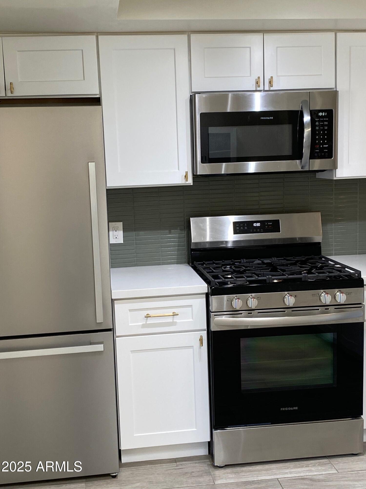 1821 West Libby Street Phoenix, AZ 85023 - Photo 7 of 26 a stove top oven sitting inside of a kitchen