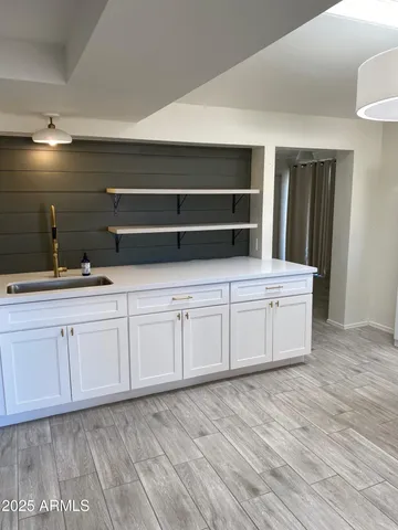 a kitchen with stainless steel appliances granite countertop a sink and a stove
